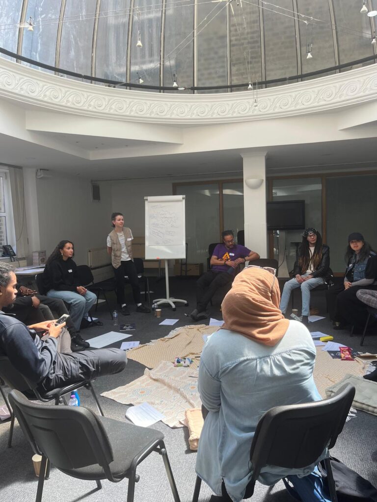 Photo of Shakers discussing, with Latifa facilitating 